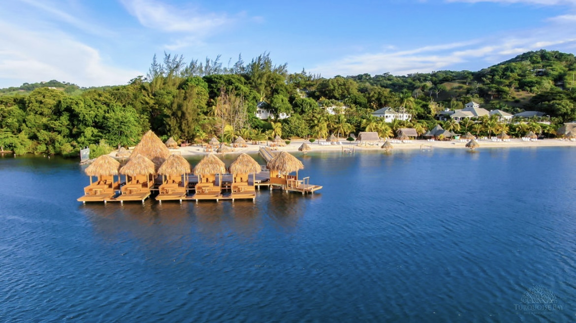 Various decks in the waters with grass roofs and seating areas